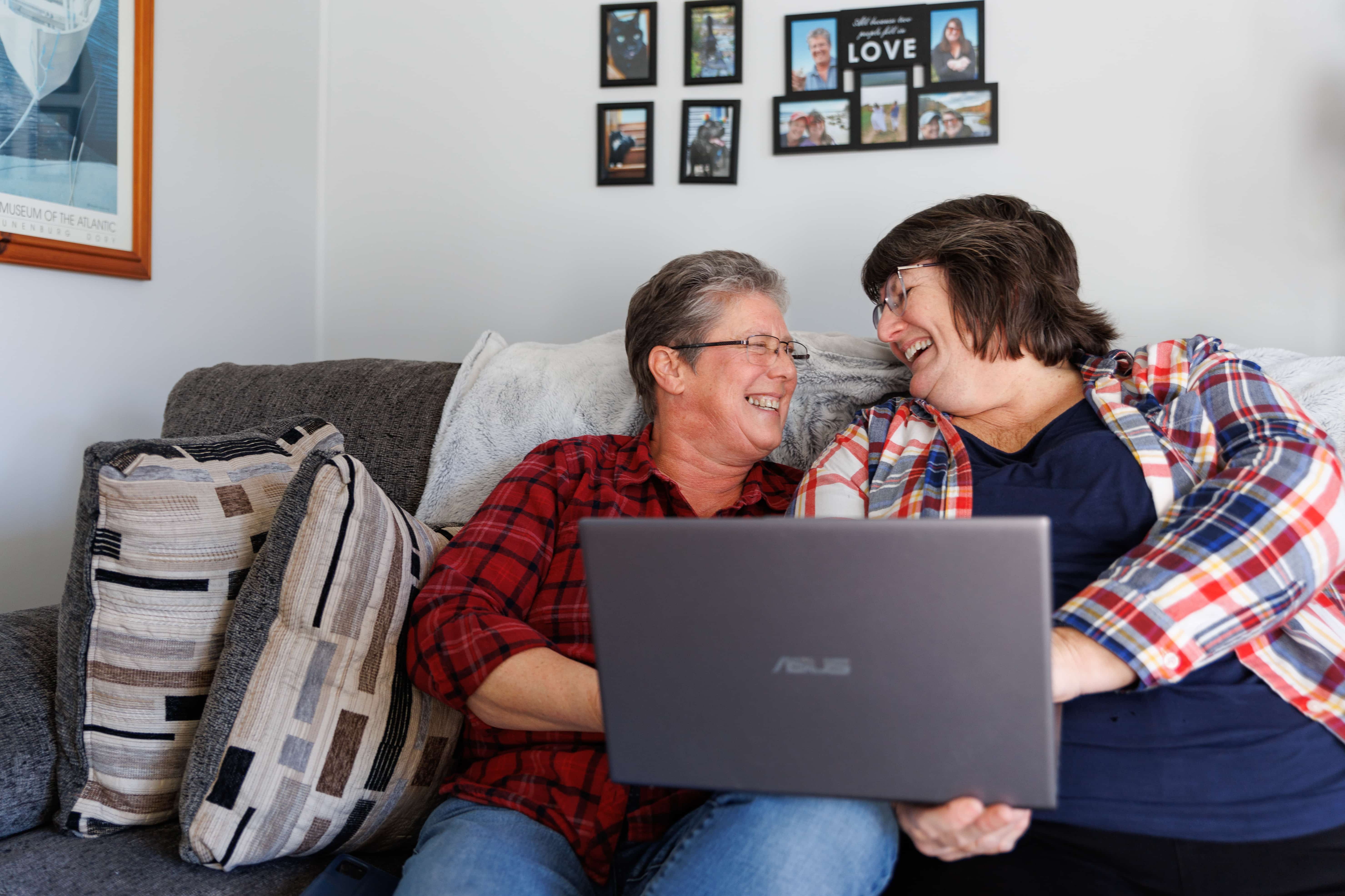 Two people hugging each other in front of a house